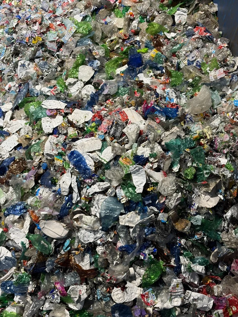 Mixed post-consumer plastic bottles and packaging stream before optical inspection